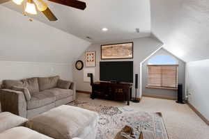Living area featuring a ceiling fan and carpet floors