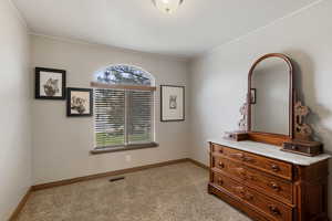 Bedroom with light carpet and baseboards