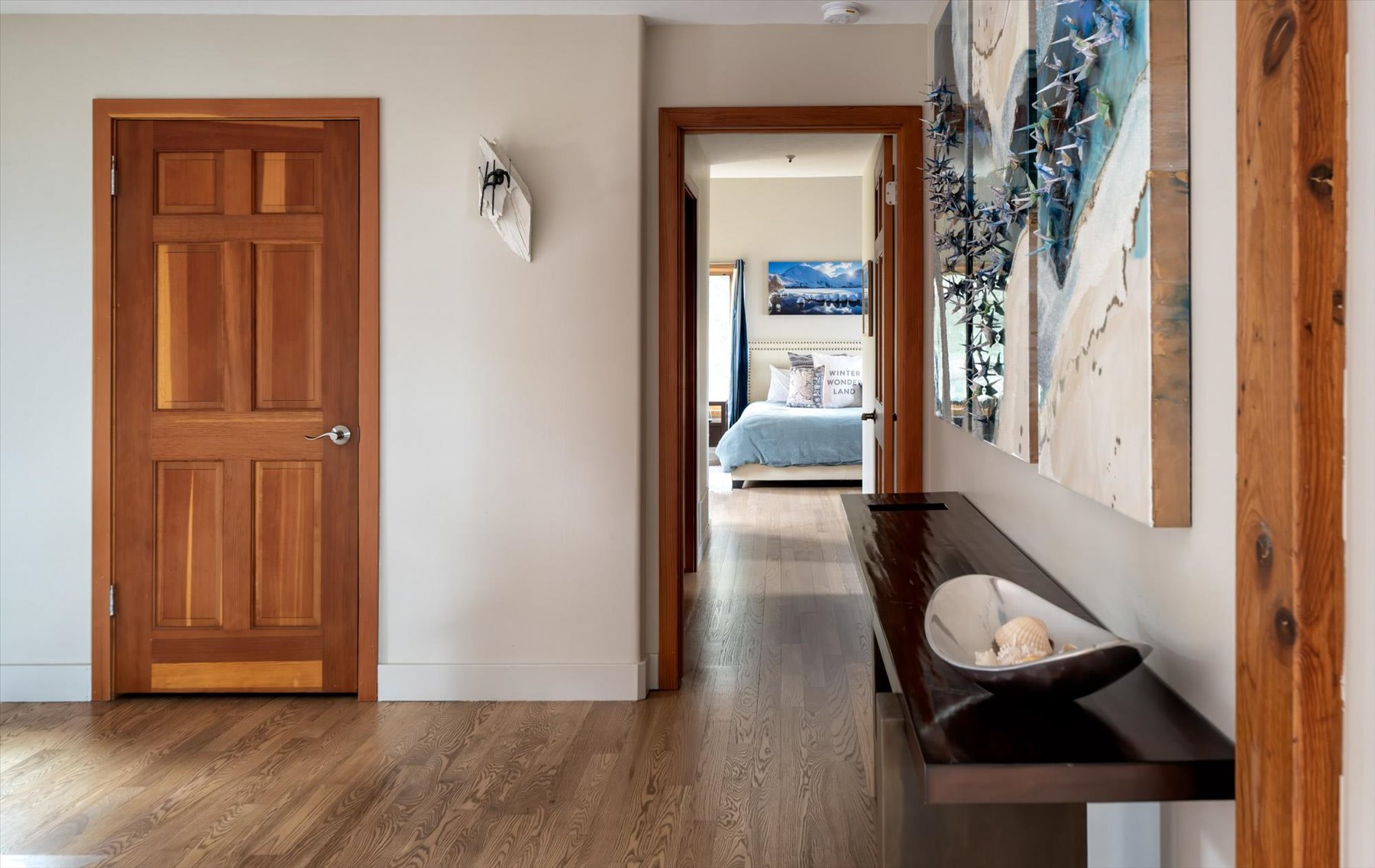Corridor featuring dark wood-style floors and baseboards