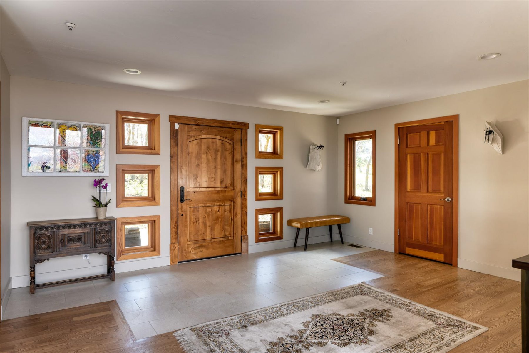 Foyer entrance with light wood-type flooring and baseboards
