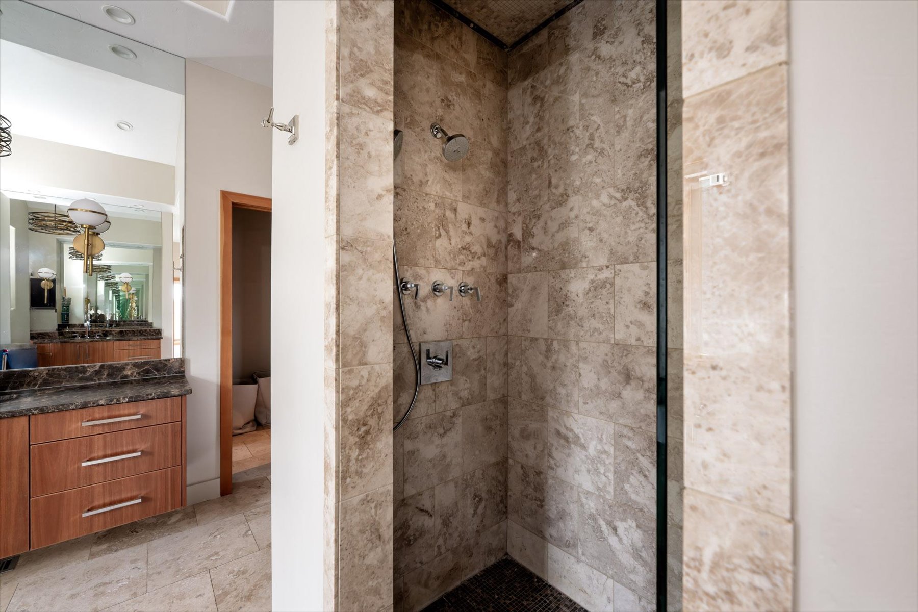 Bathroom with a tile shower and vanity