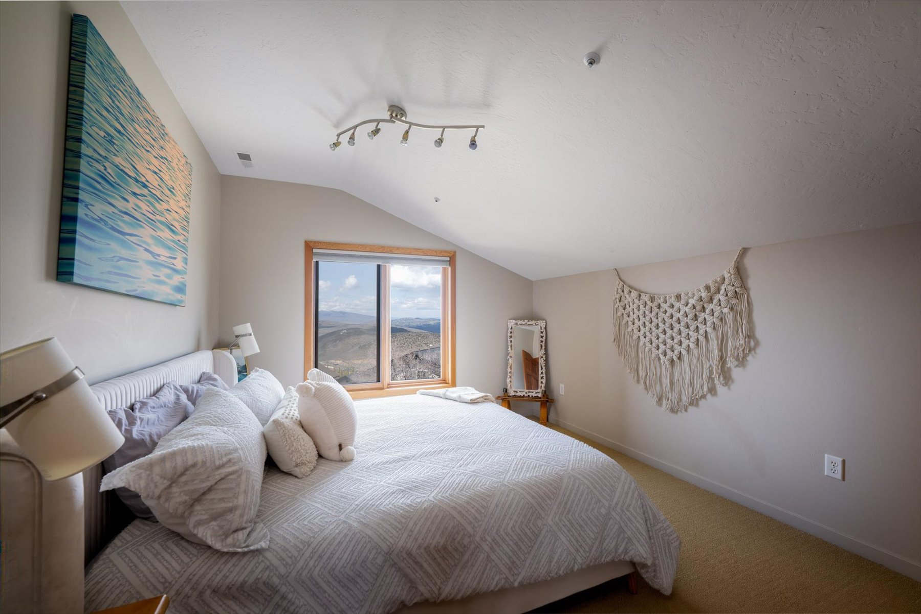 Bedroom with vaulted ceiling and carpet flooring