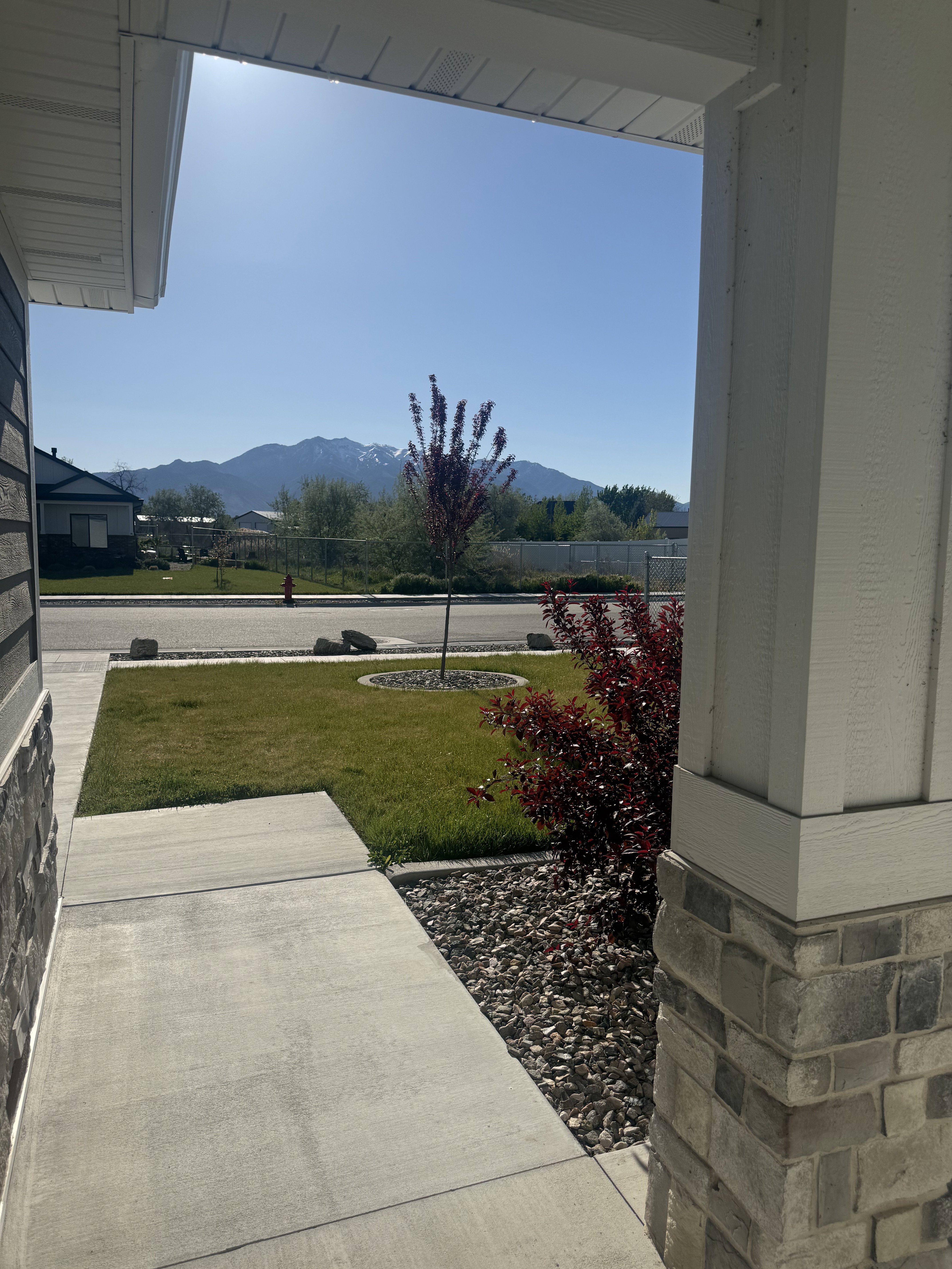 Porch with a yard and a mountain view