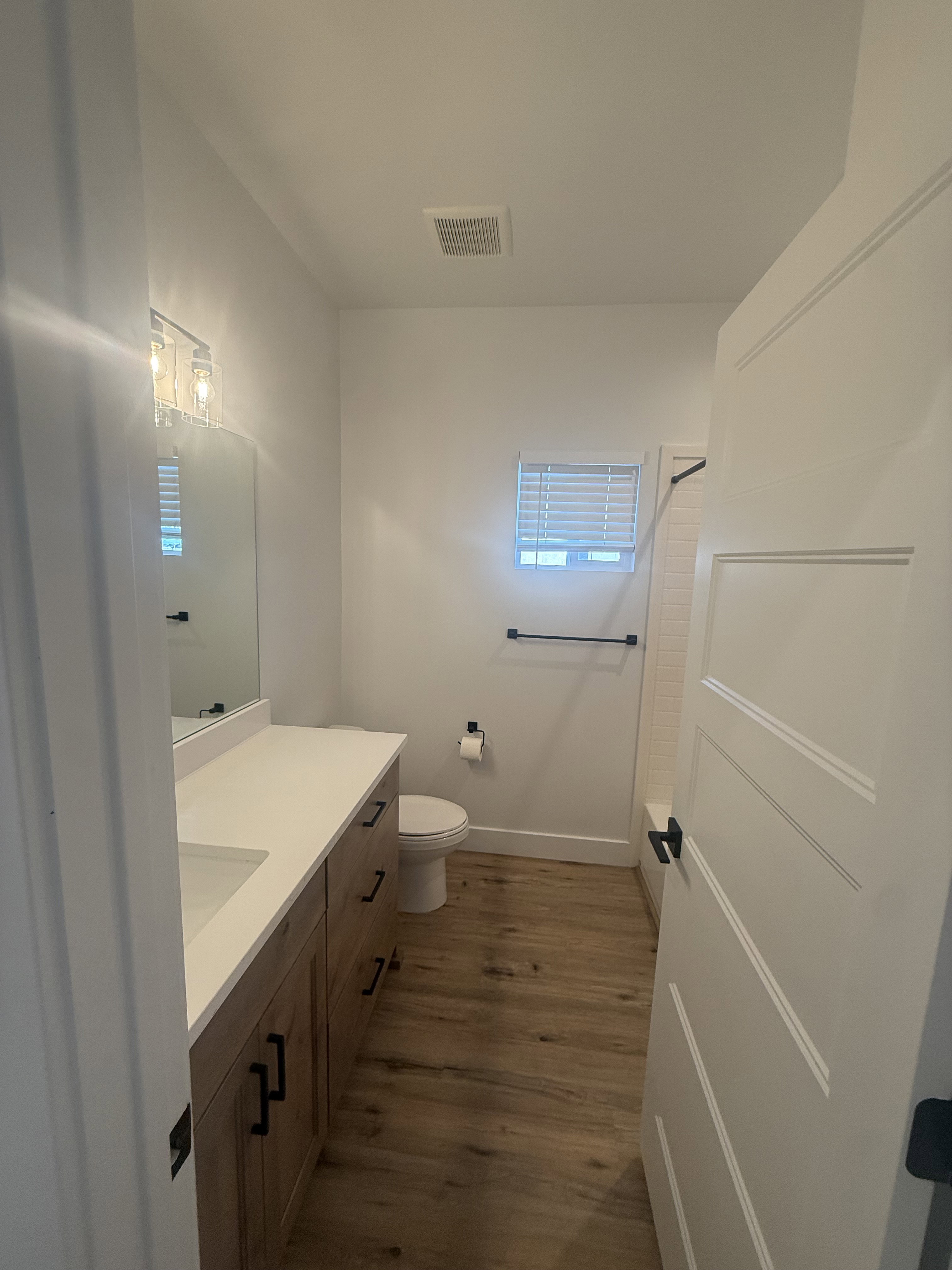 Full bathroom featuring vanity, dark wood finished floors, and bathtub / shower combination