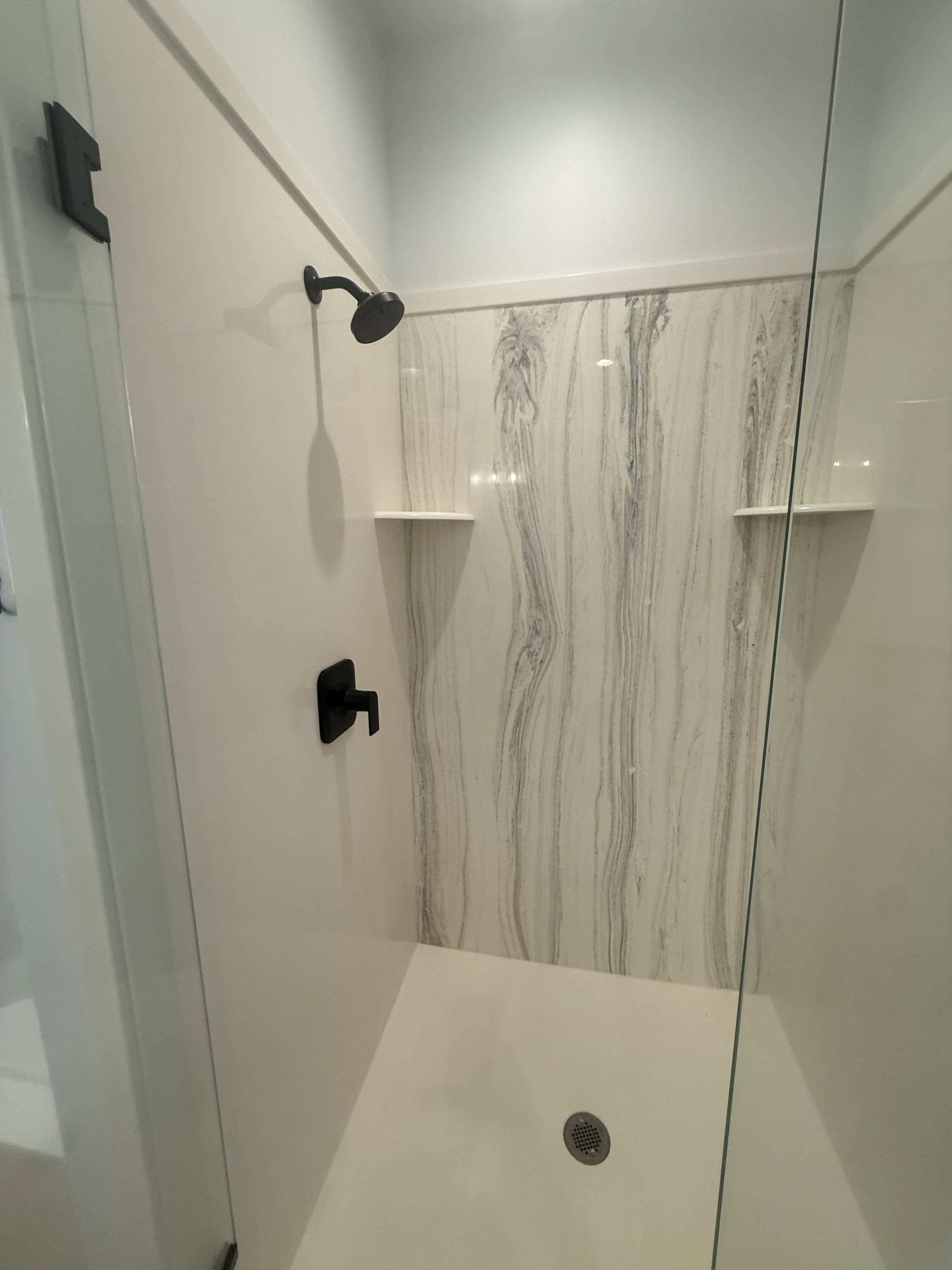 Bathroom with a marble finish shower