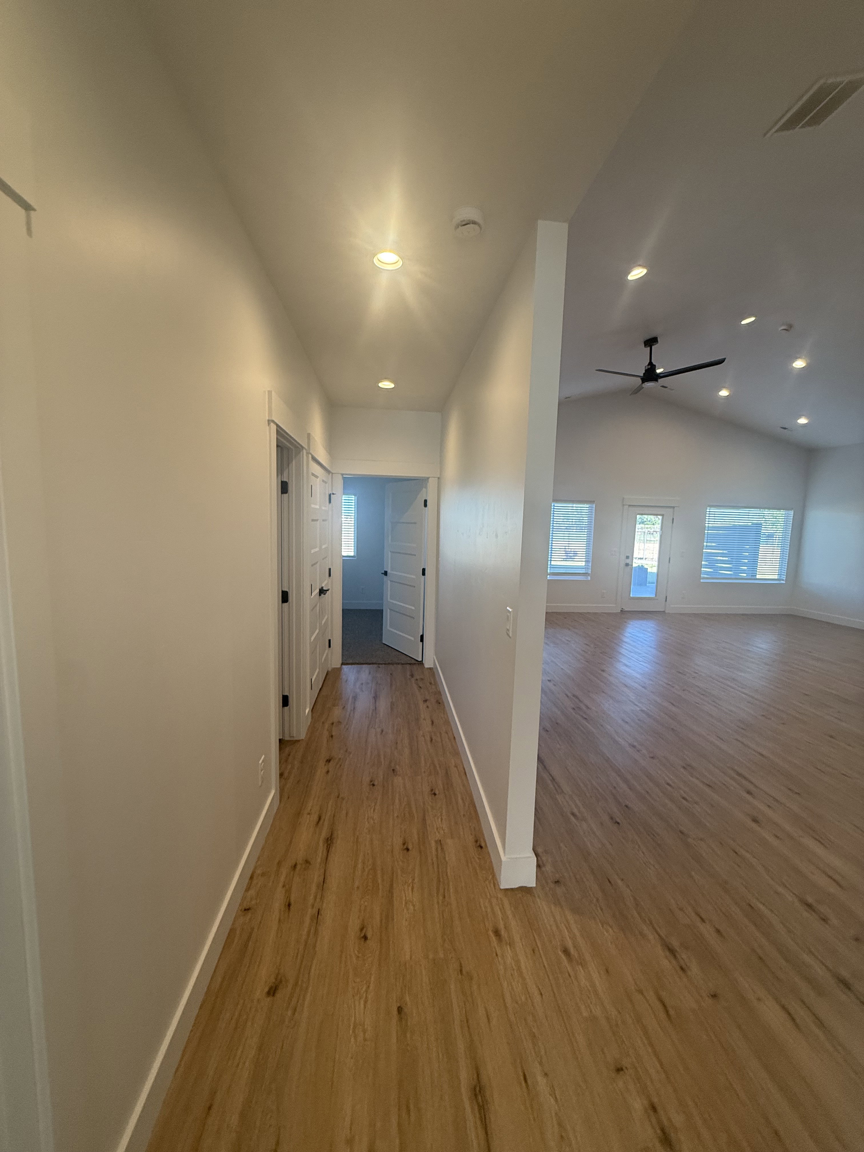 Hall with light wood-style flooring, recessed lighting, and lofted ceiling