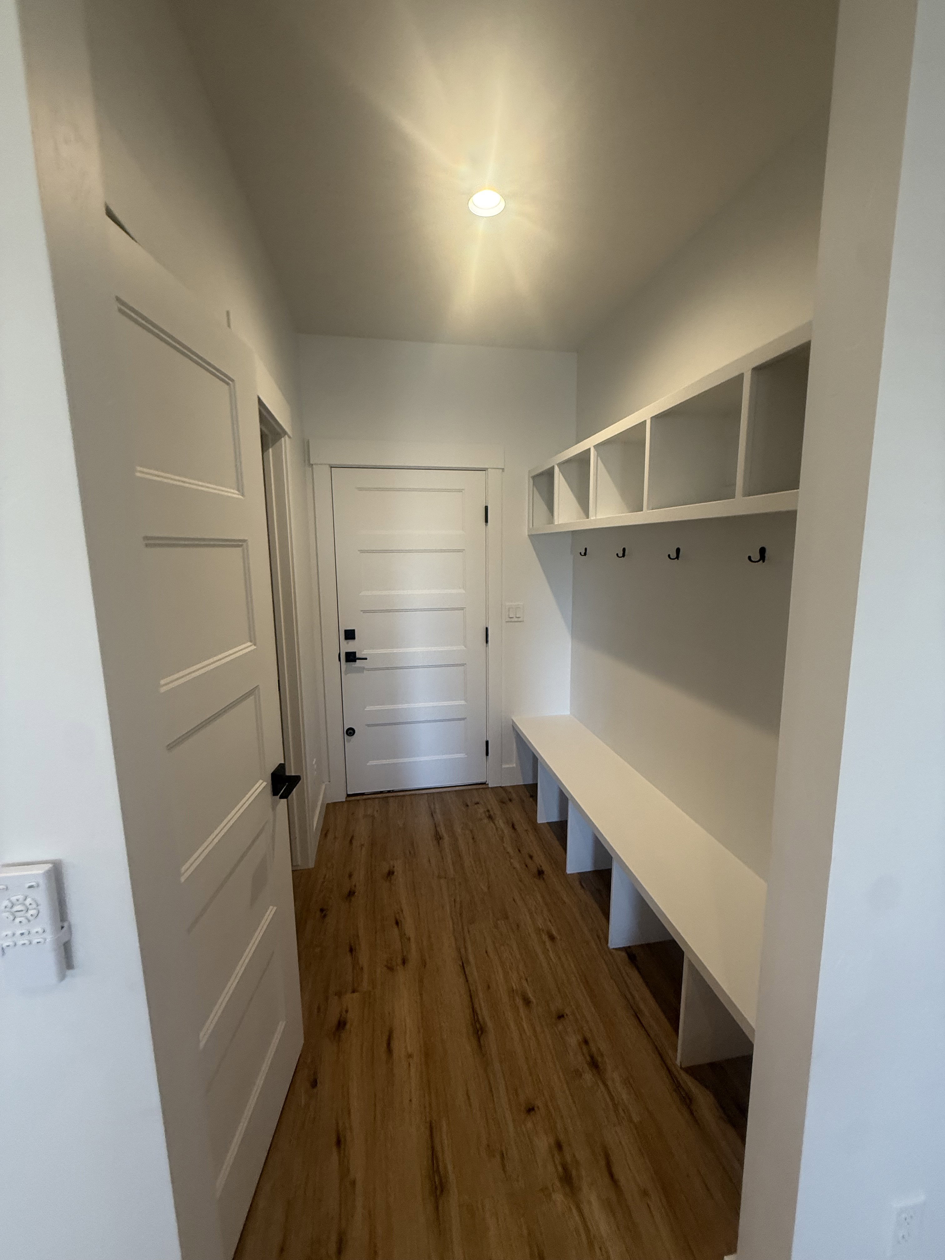 Mudroom with dark wood-style flooring