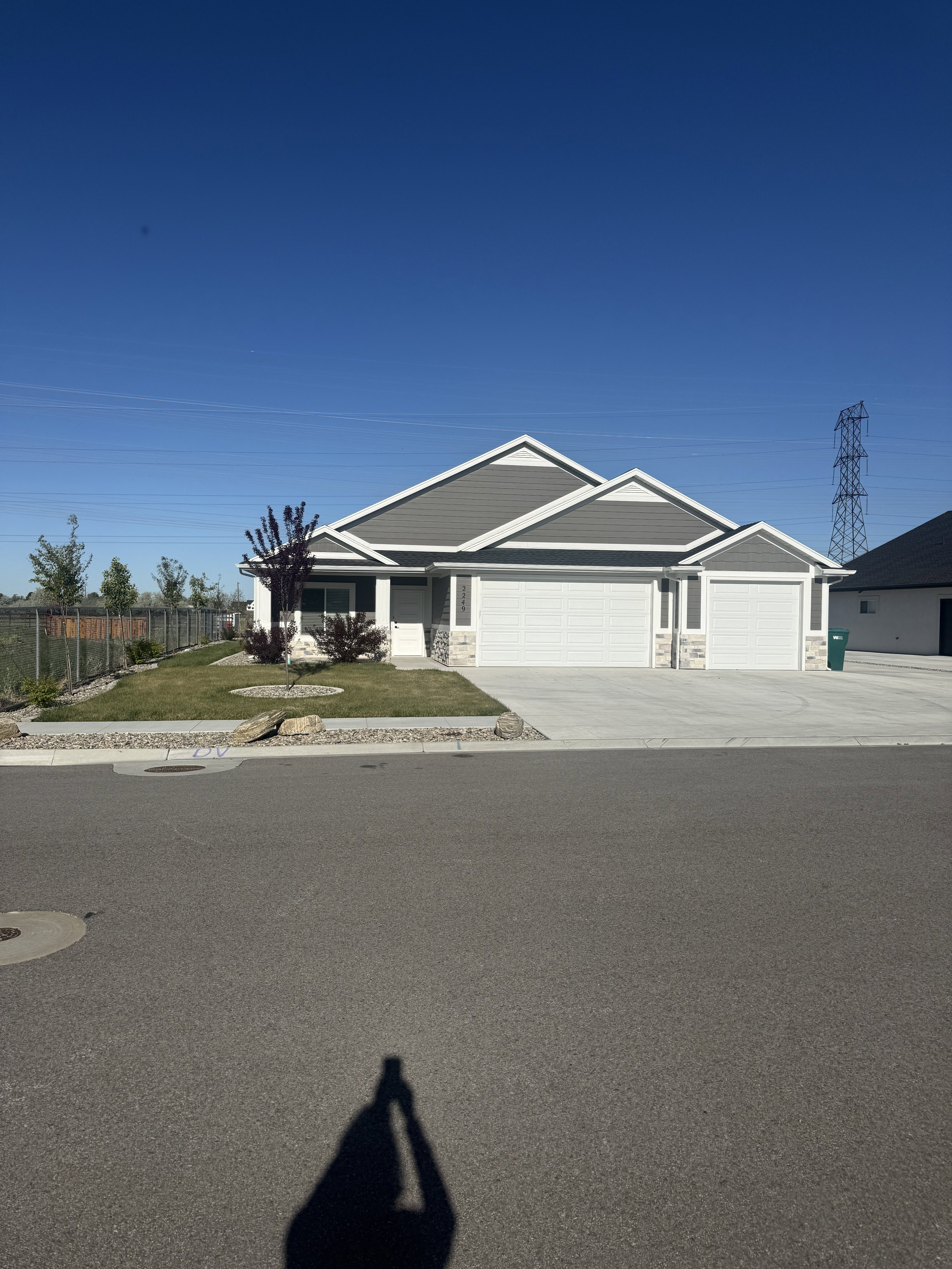 View of front of house with stone siding, an attached garage, and concrete driveway