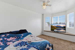 Bedroom featuring carpet flooring and a ceiling fan