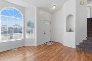 Entrance foyer with light wood-style flooring and baseboards