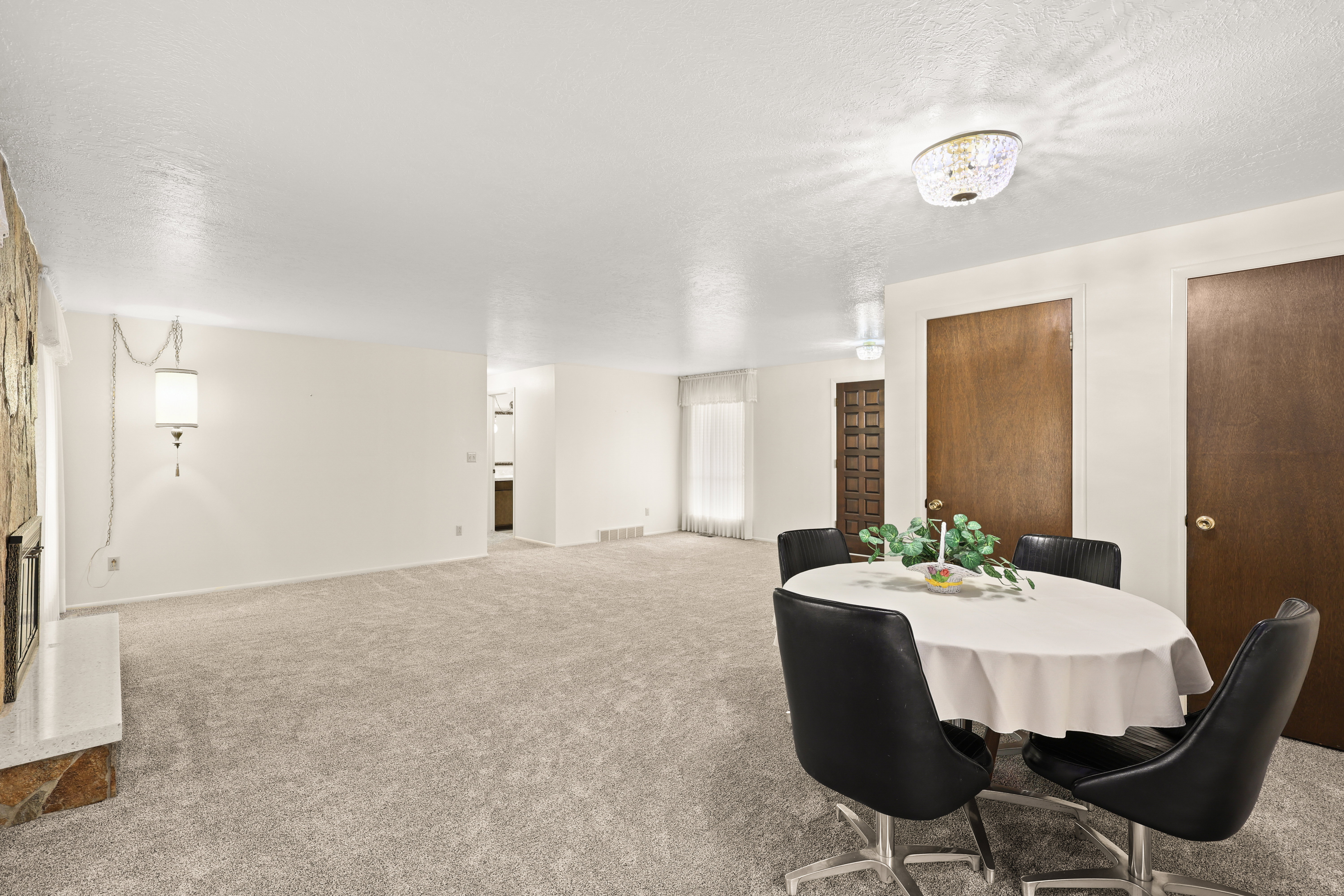 Open-concept living area featuring new carpet and neutral wall colors