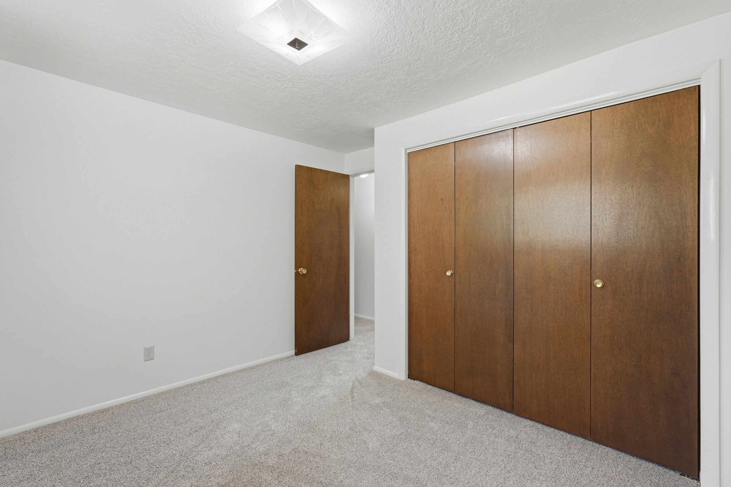 Bedroom featuring light-colored carpet flooring and white walls