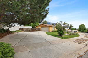 View of front of home featuring driveway, a mountain view, and a garage