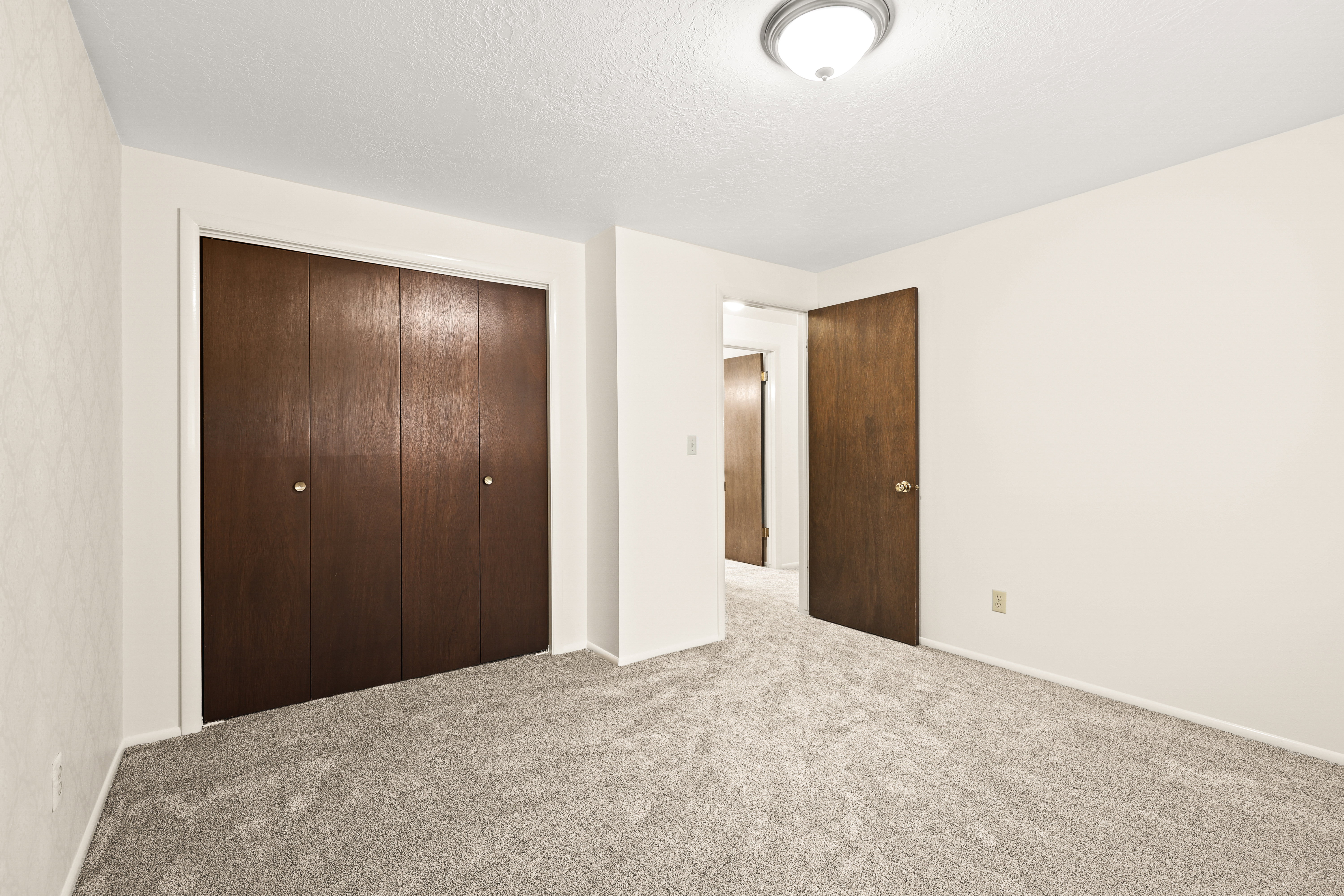 Neutral wall finishes complement the textured ceiling
