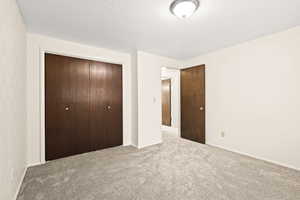 Neutral wall finishes complement the textured ceiling