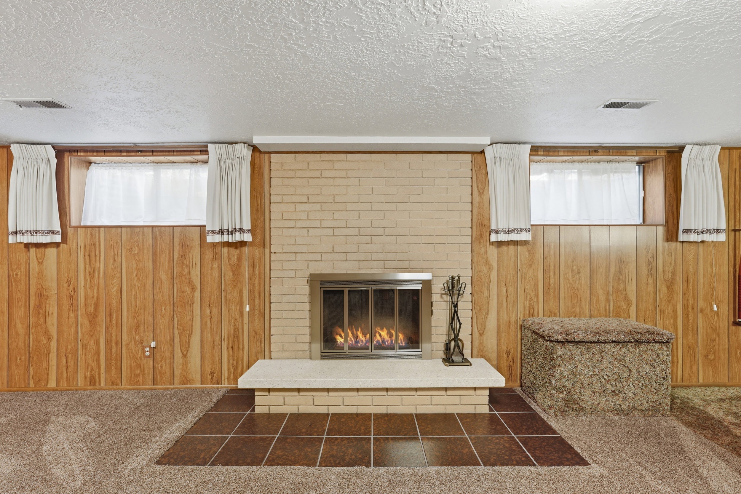 Brick fireplace with a raised hearth, and brick surround
