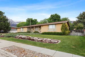 Ranch-style house with brick siding, a mountain view, and a porch