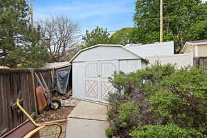 View of shed with a fenced backyard