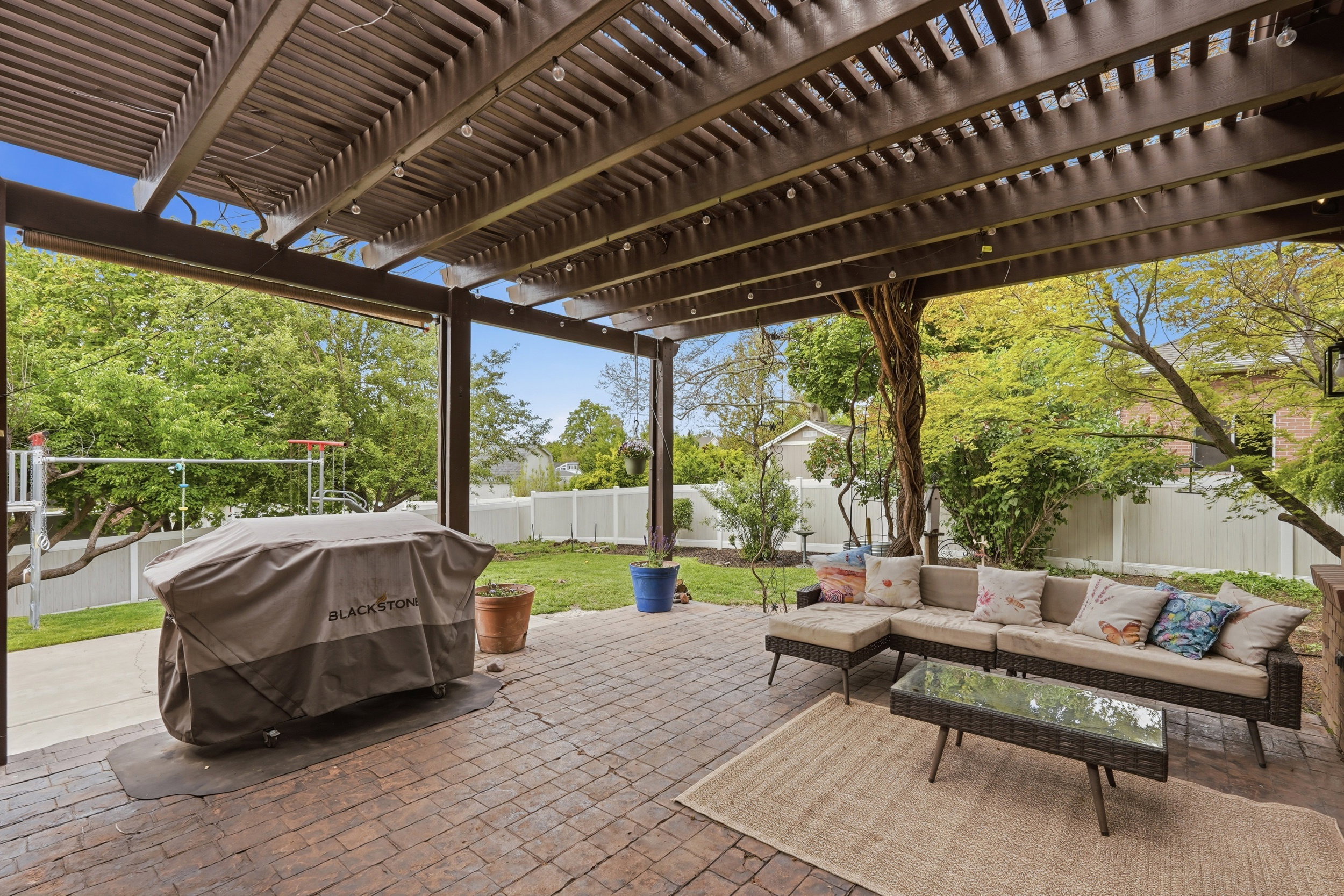 Fenced backyard featuring a pergola, area for grilling, outdoor furniture, and a patio area