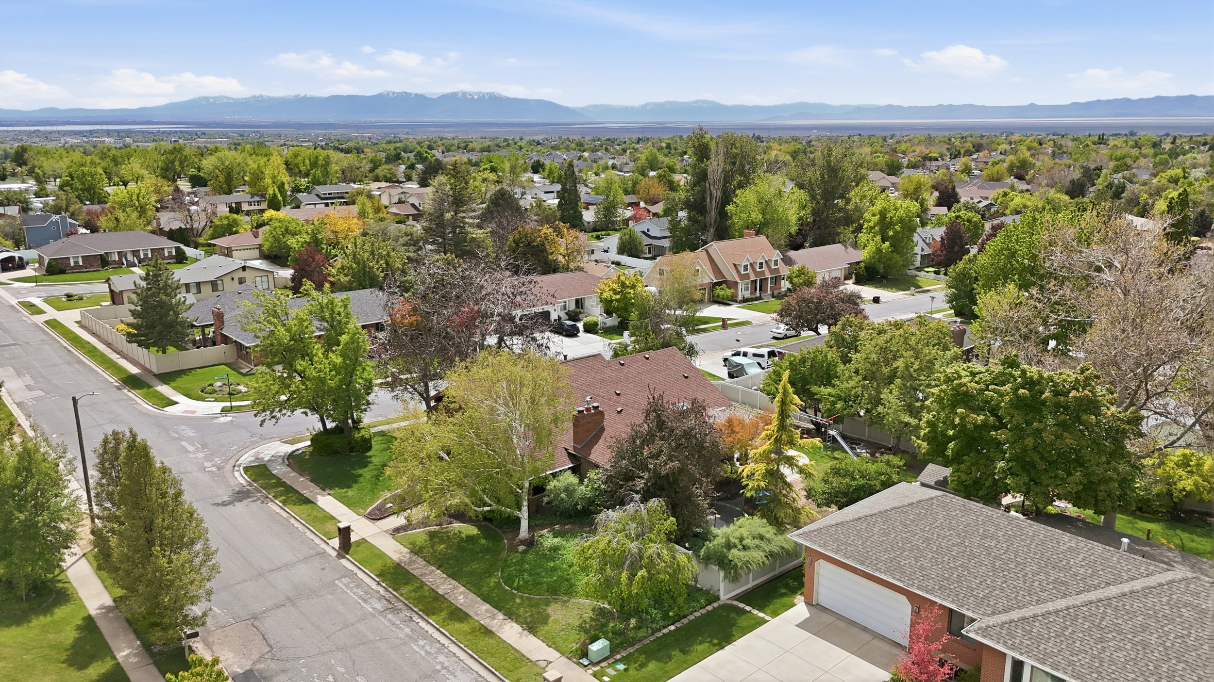Aerial perspective of suburban area featuring a mountain backdrop