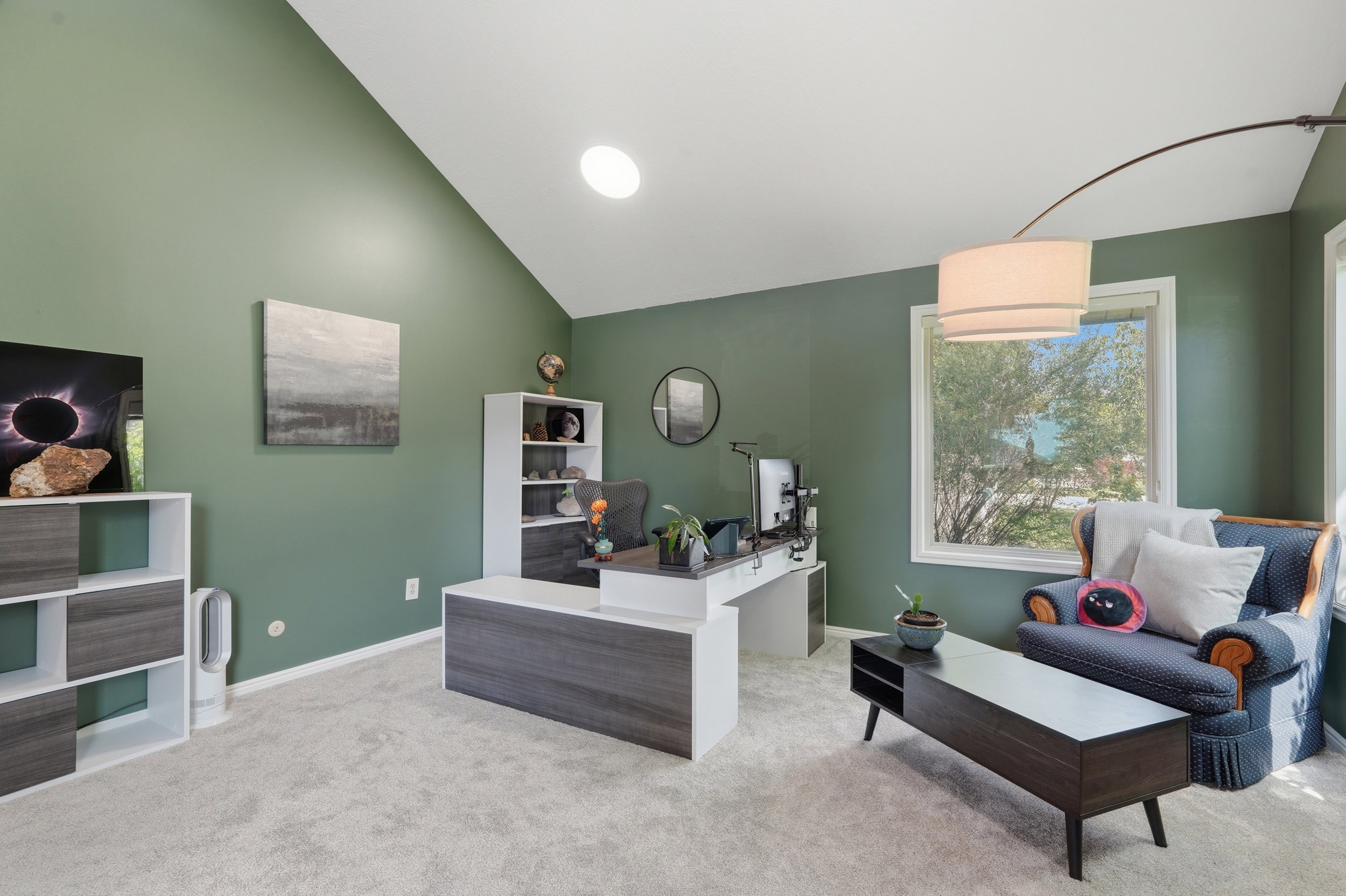 Living room / Office Space just off the entry with lofted ceiling and light colored carpet