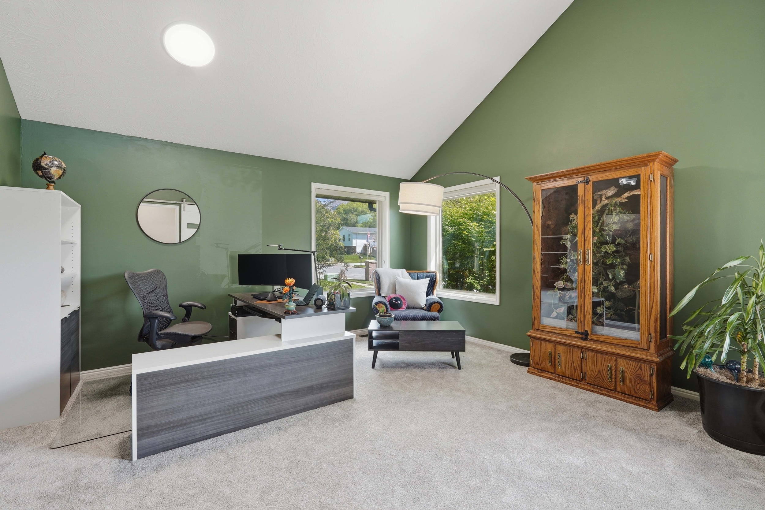 Living room / Office Space just off the entry with lofted ceiling and light colored carpet