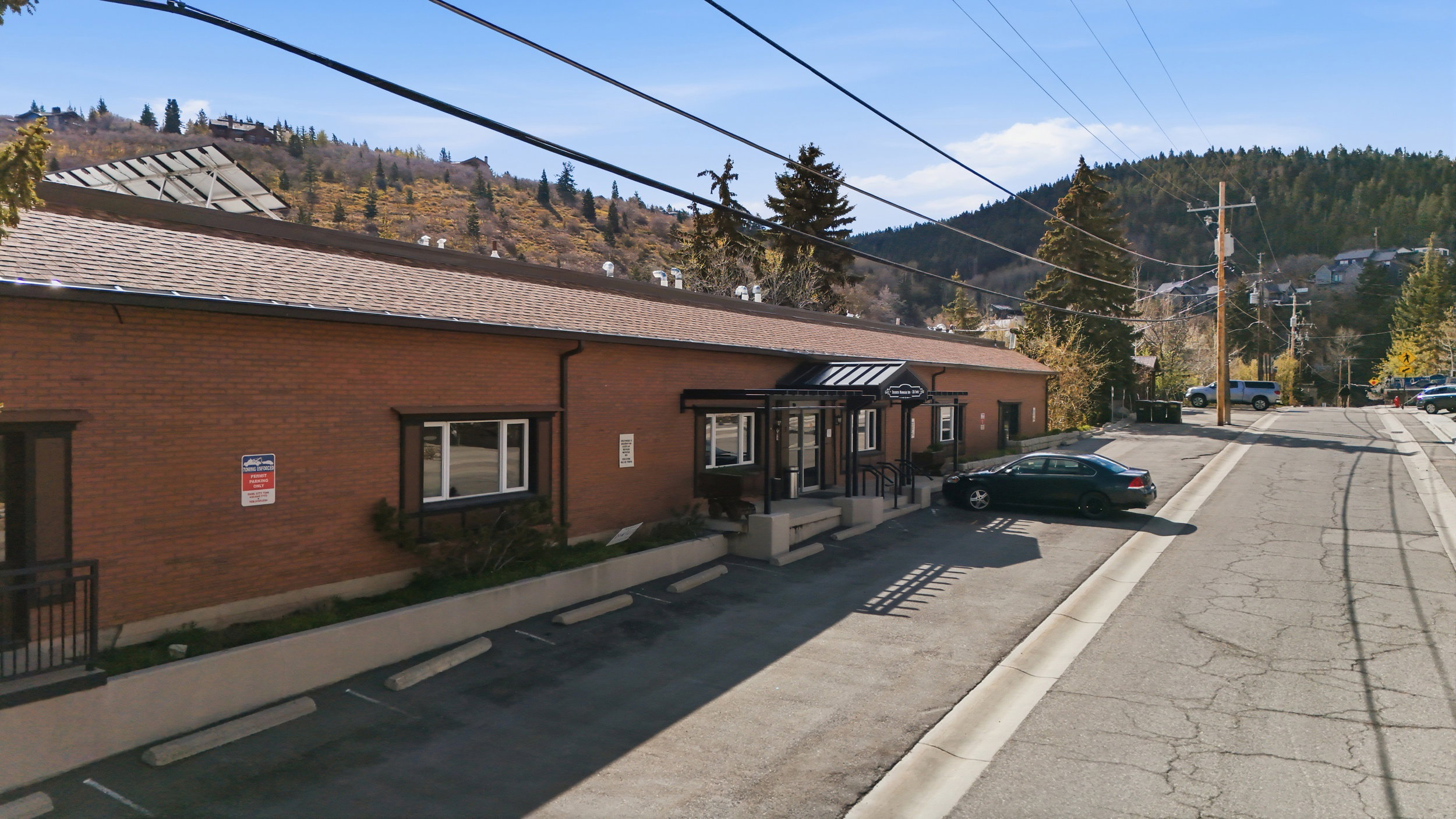 View of building exterior with uncovered parking