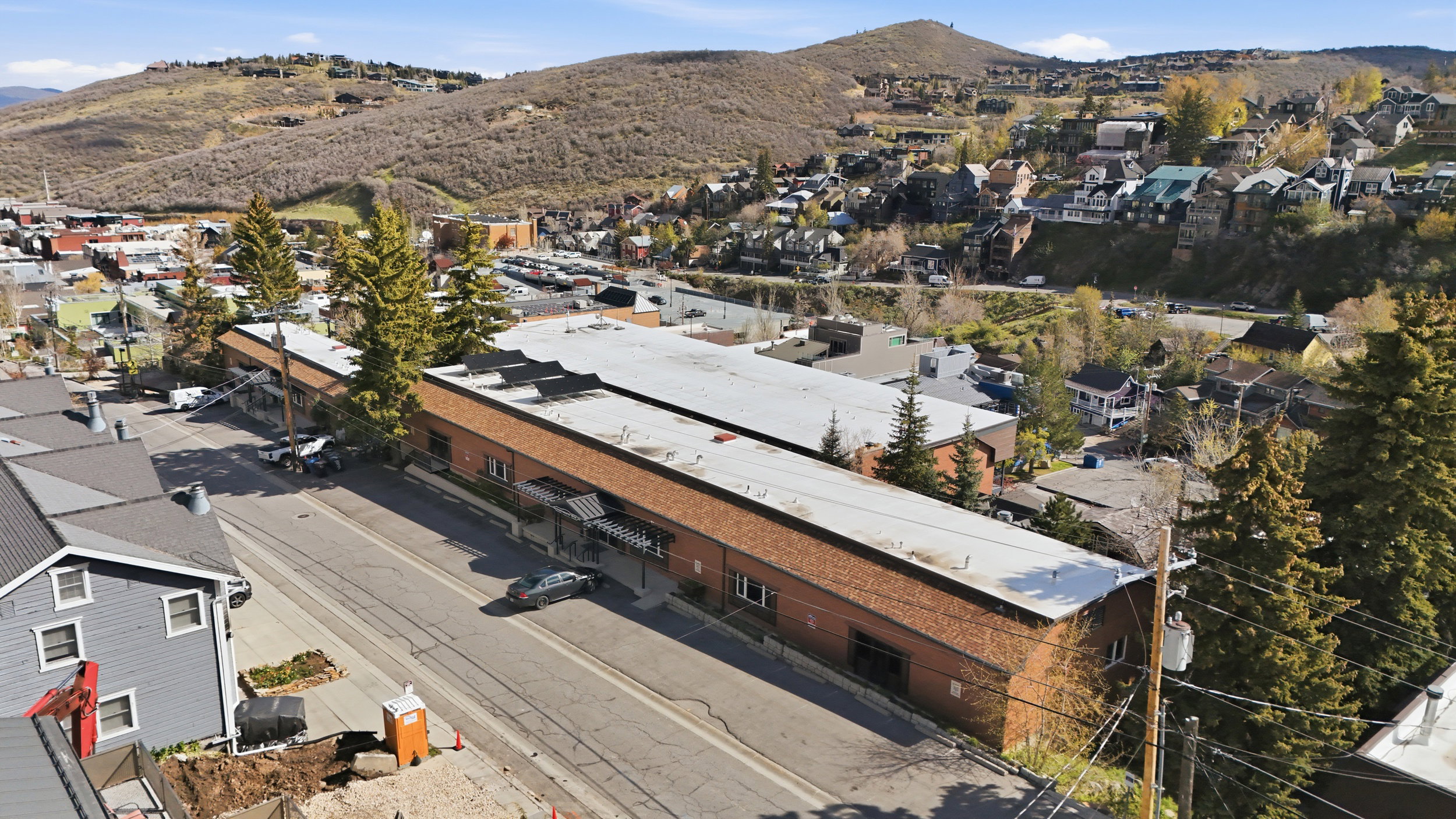 Aerial perspective of suburban area featuring a mountain backdrop