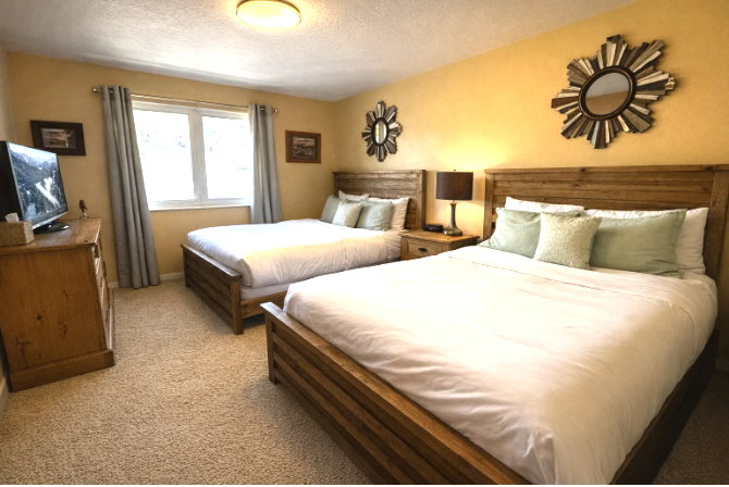 Bedroom with a textured ceiling and light colored carpet