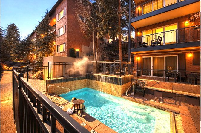 View of swimming pool featuring patio surround, a fenced backyard, and a balcony