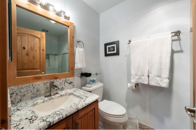 Bathroom featuring vanity and a shower