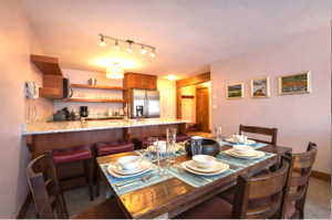 Dining room with track lighting and dark colored carpet
