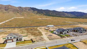 View of rural area with a mountainous background and nearby suburban area