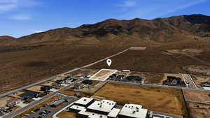 View of property location with a mountain backdrop and nearby suburban area