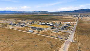 Aerial view of property's location with nearby suburban area, mountains, and rural landscape