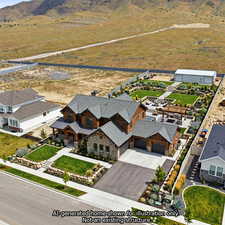 Aerial view of residential area featuring a mountain backdrop with AI built custom home.