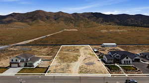 Overview of rural landscape featuring property parcel outlined and a mountainous background