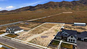 Aerial view of sparsely populated area with mountains and property parcel outlined