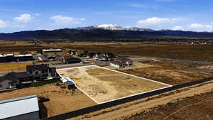 Aerial view of residential area featuring a mountain backdrop and property parcel outlined