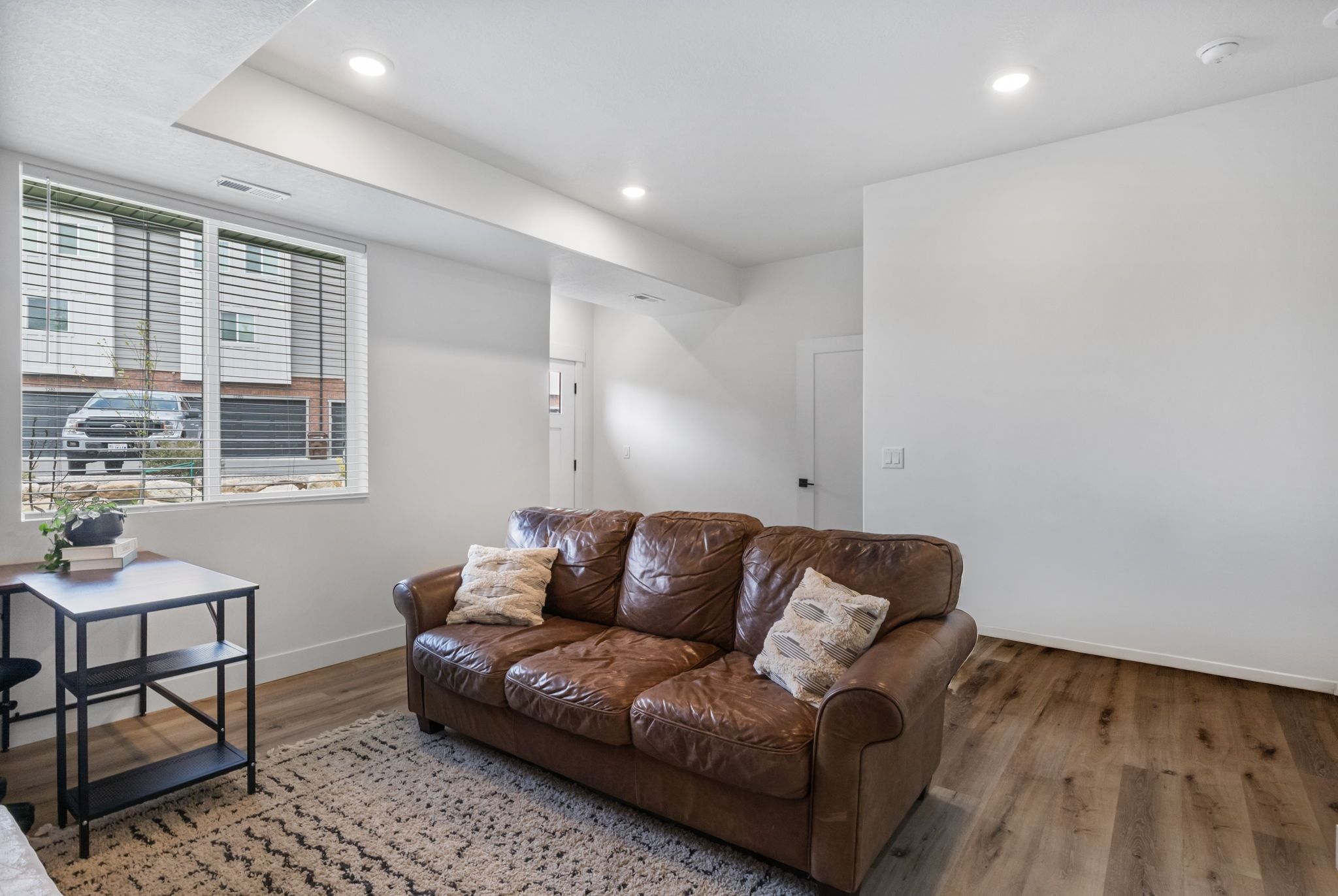 Living room with recessed lighting and wood finished floors