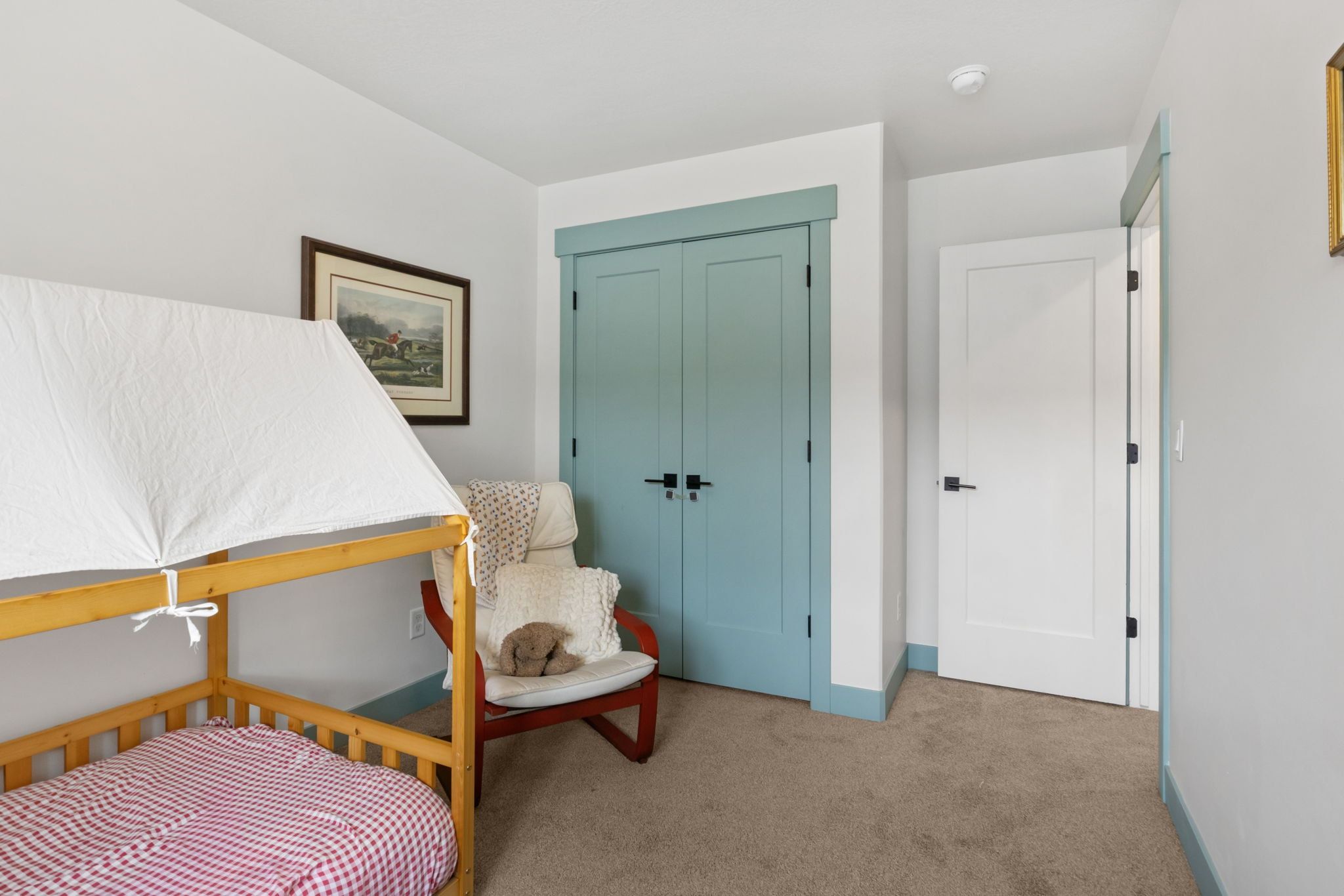 Bedroom featuring light carpet and a closet