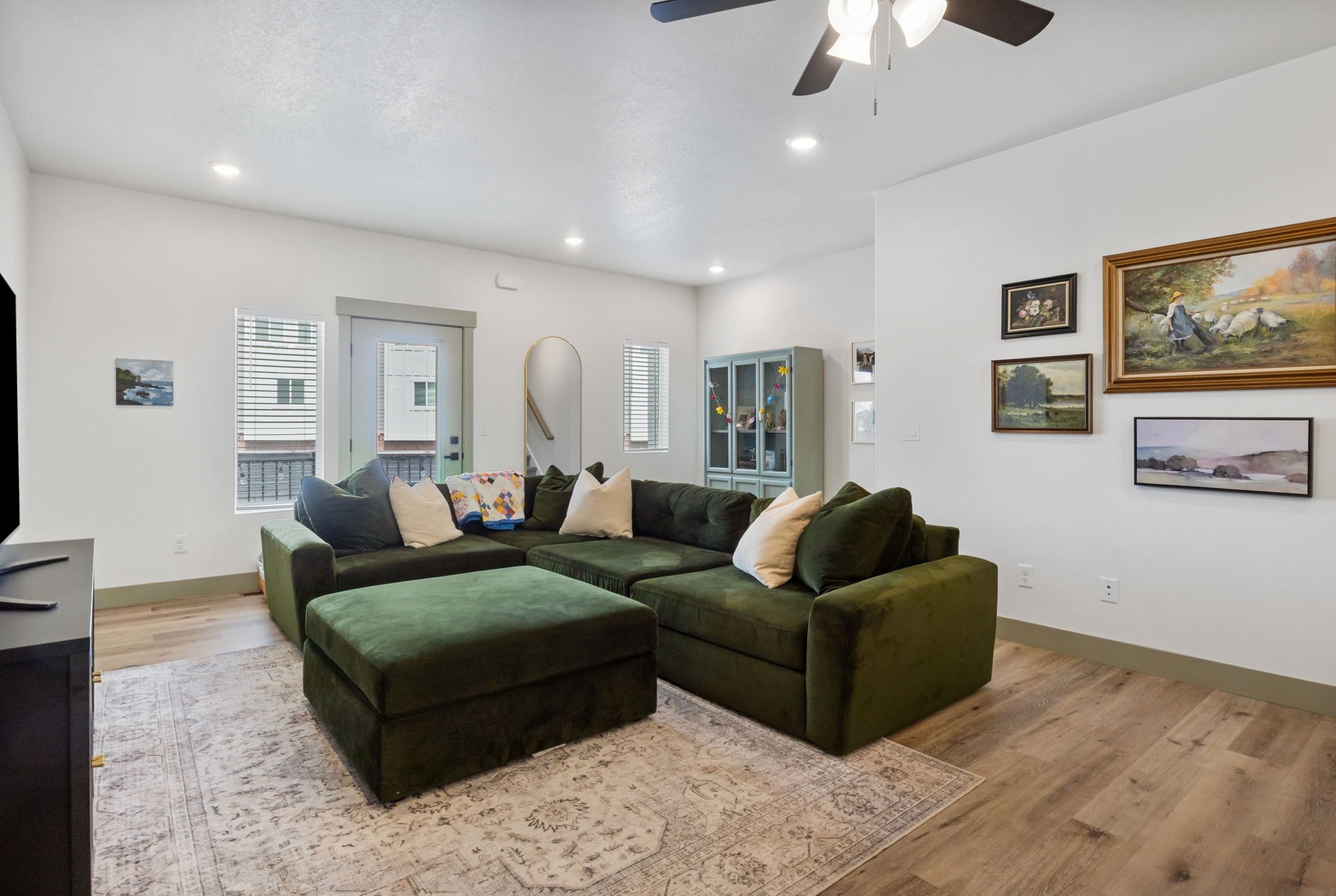 Living area featuring light wood-style flooring, ceiling fan, and recessed lighting