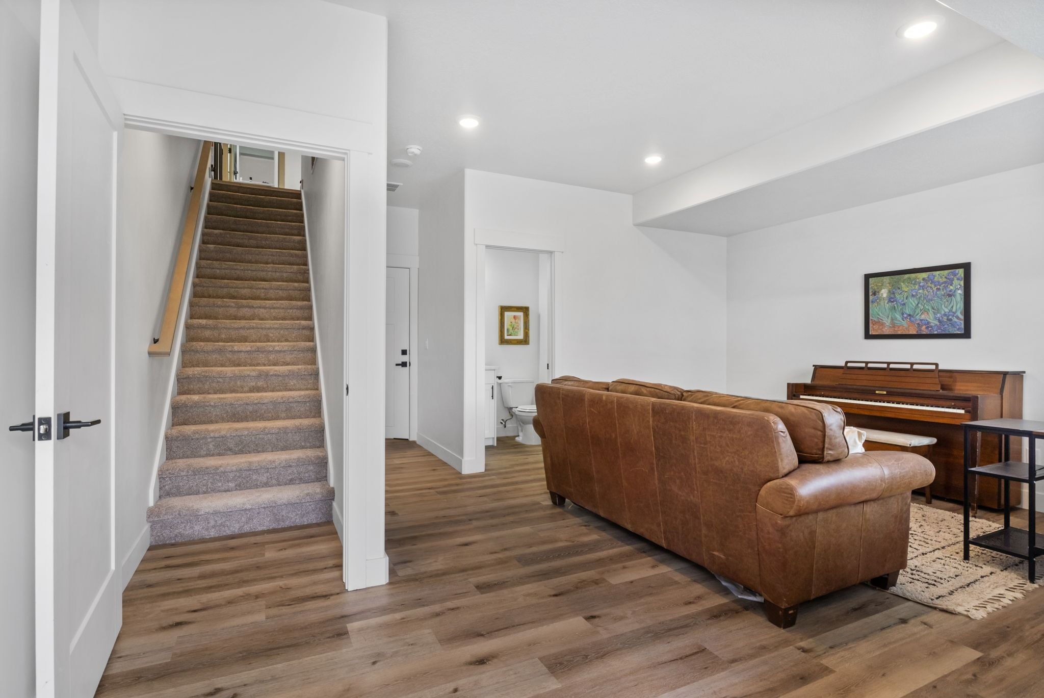 Living area featuring wood finished floors and recessed lighting