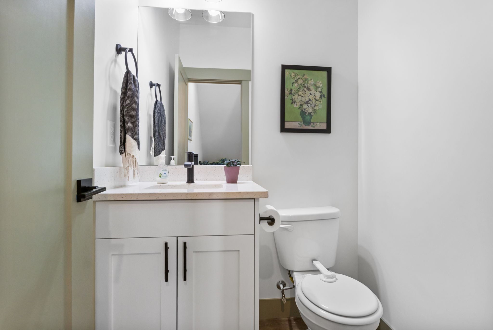 Half bathroom featuring vanity and toilet