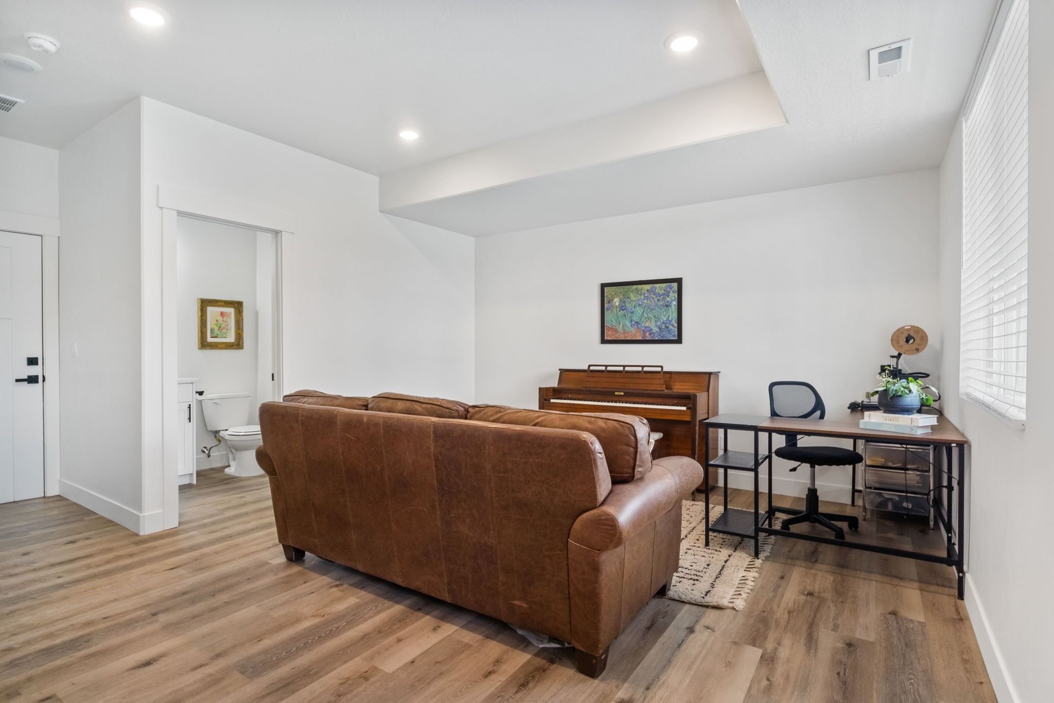 Living area featuring light wood-type flooring and recessed lighting