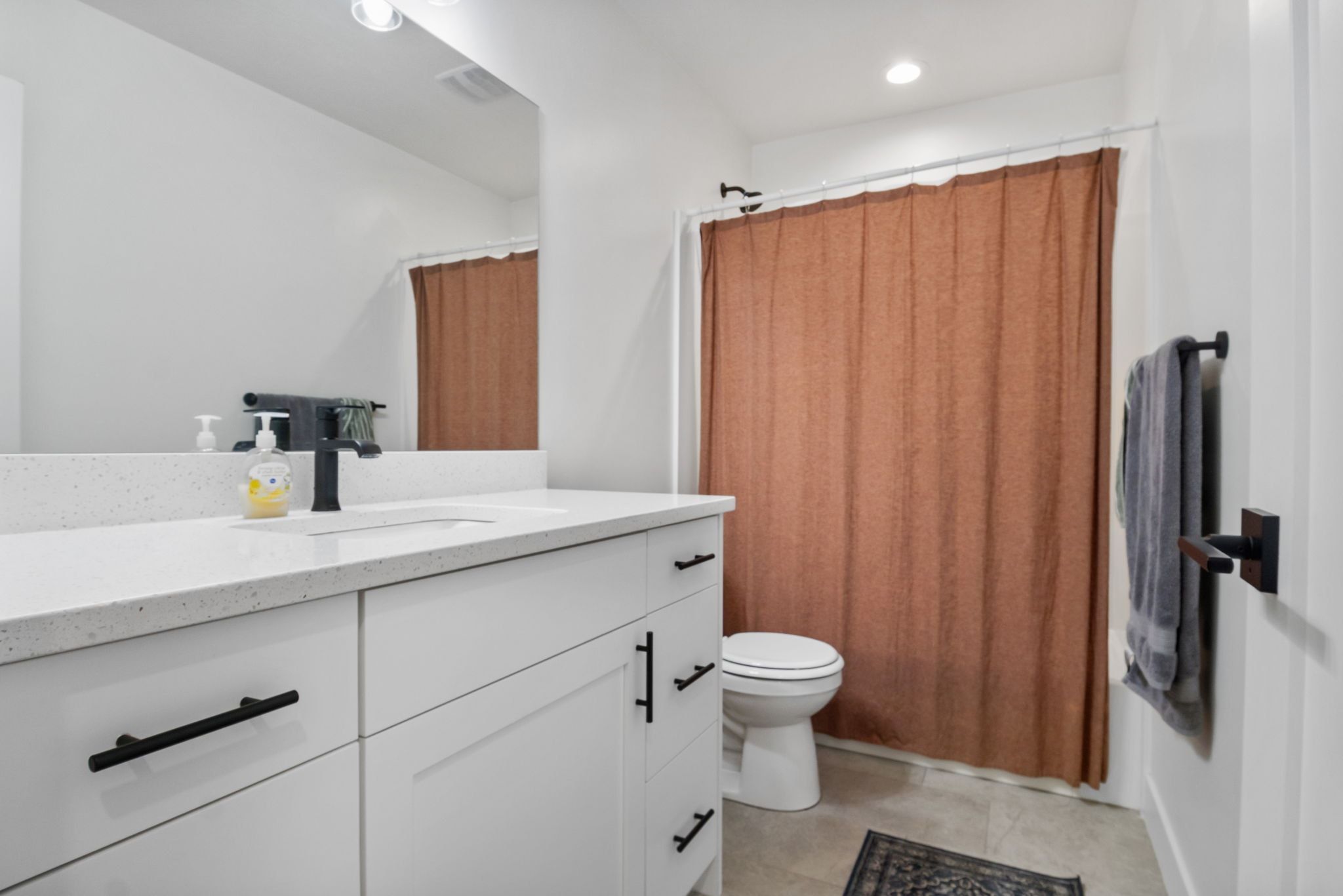 Full bathroom featuring vanity, a shower with shower curtain, and recessed lighting