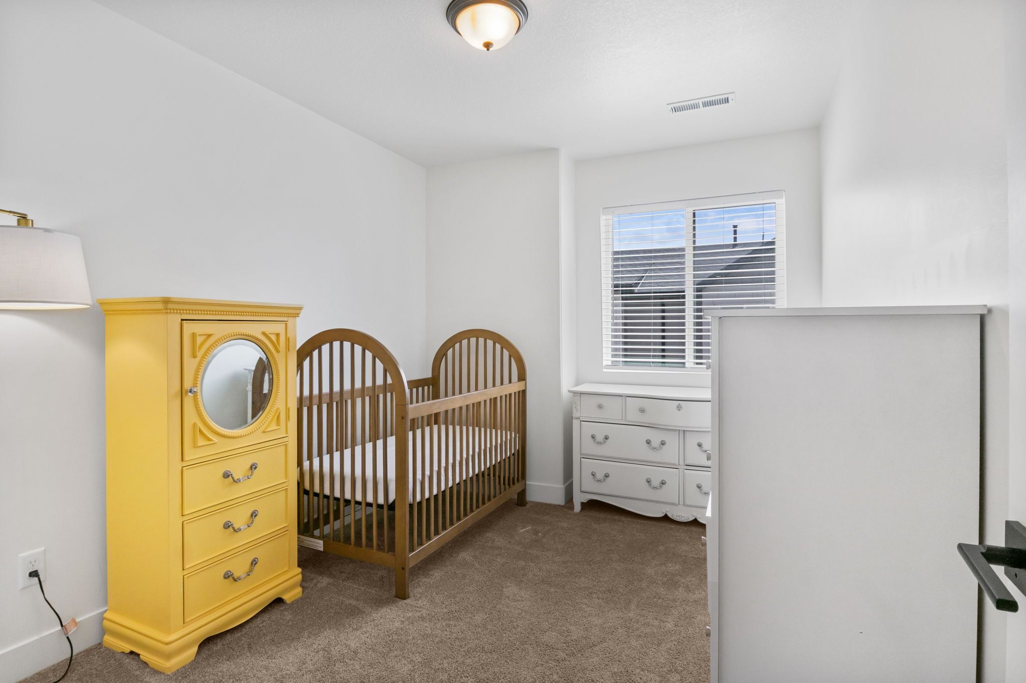 Bedroom featuring dark carpet and baseboards