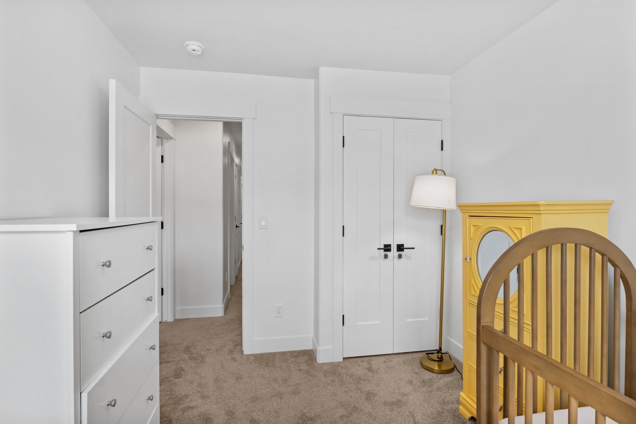 Bedroom with light carpet and a closet
