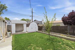 Fenced backyard with a storage shed
