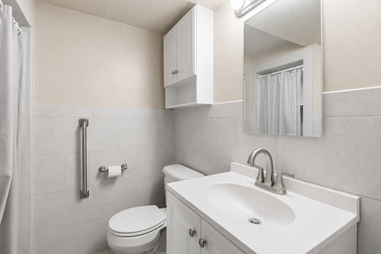 Bathroom with vanity, a shower with shower curtain, and tile walls